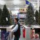 A shopper at a Lowe’s home improvement store walks by a display of artificial Christmas trees on Nov. 4, 2010, in San Francisco.